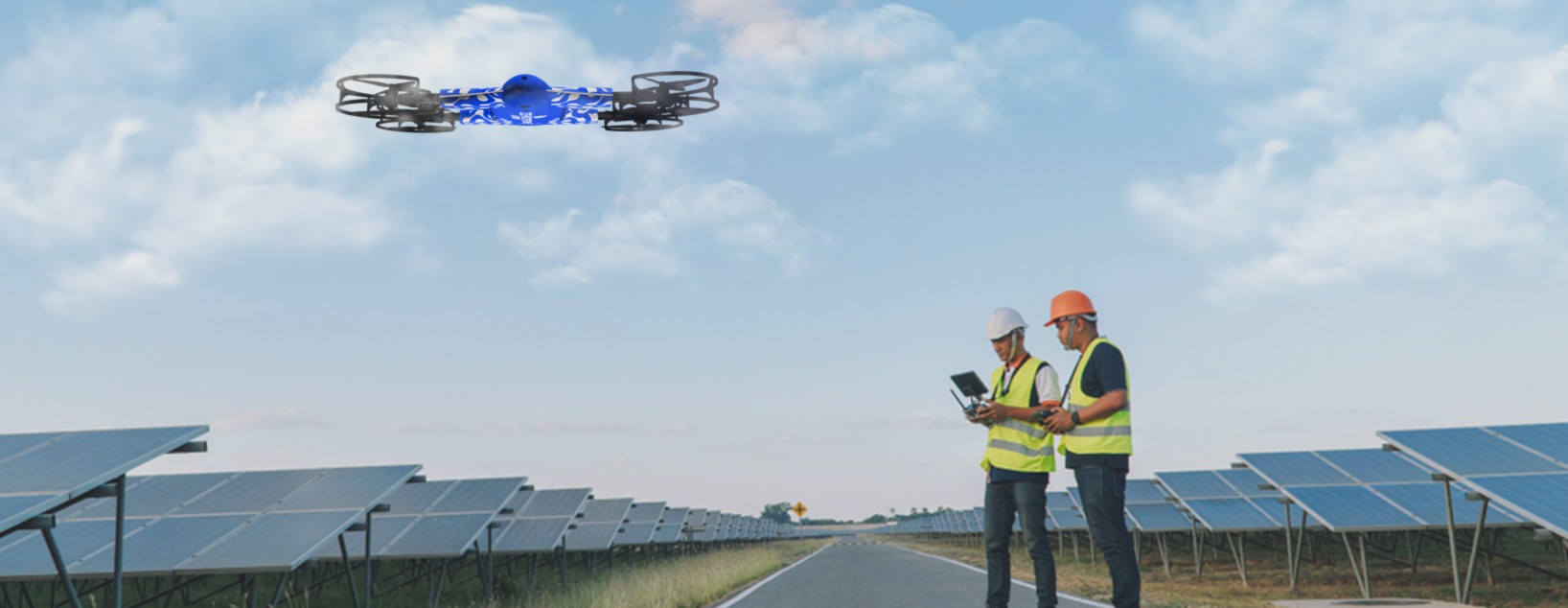 Drone pilots inspect solar panels using drones and check the data on the tablet.